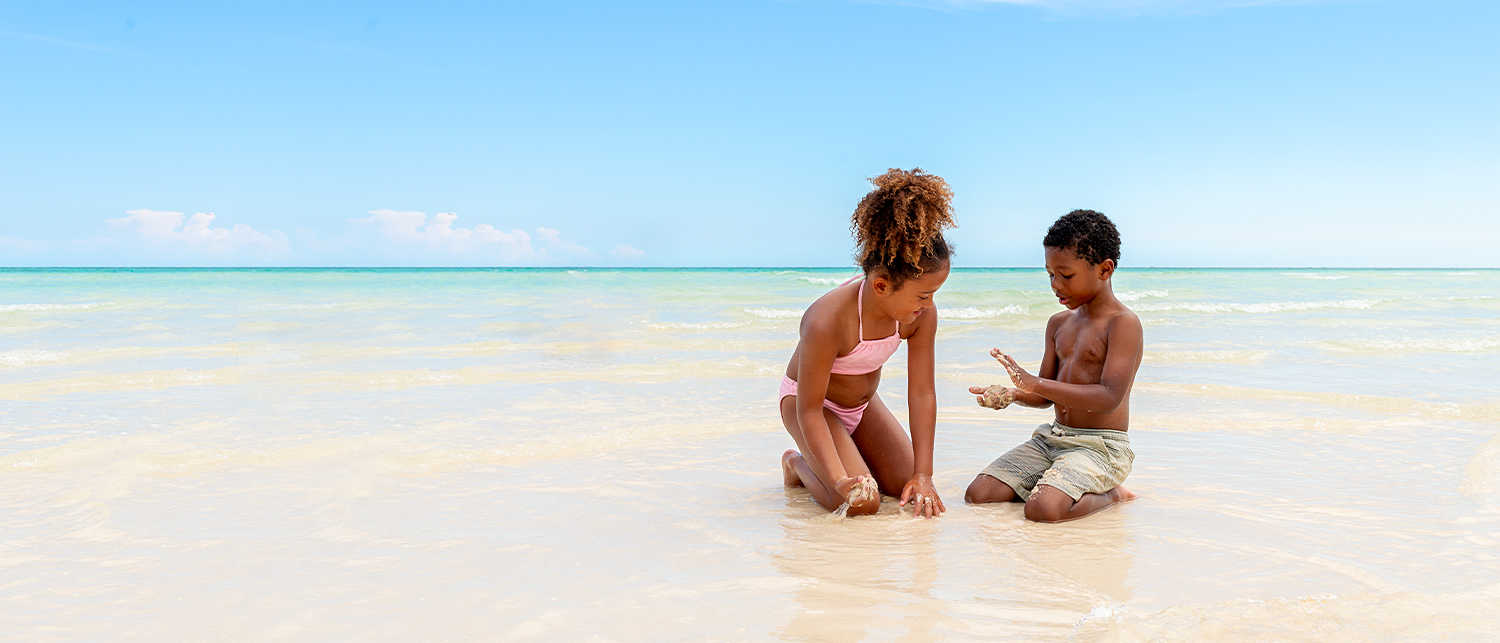 two young kidsplaying with sand