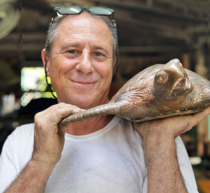 Man Holding Bronze Sculpture sea turtle