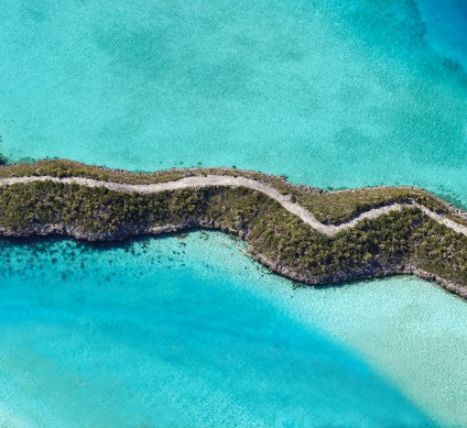 aerial view of island with road through it.