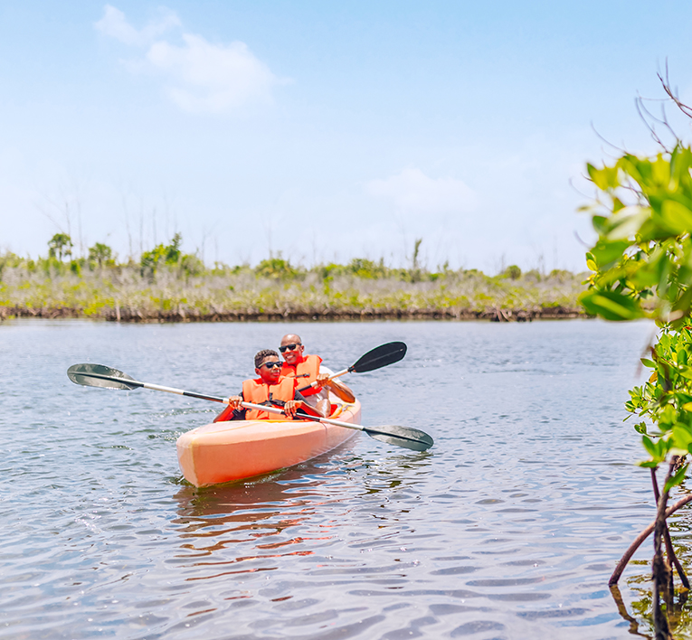 A father & son kayaking at Lucayan national park. mobile   experiences quad   765x708px